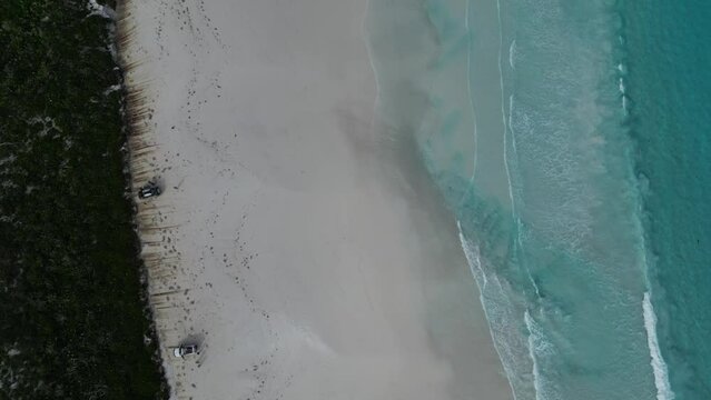 Lucky Bay beach with white sand and turquoise ocean waters, Cape Le Grand National Park, Western Australia. Aerial top-down forward and slow-motion
