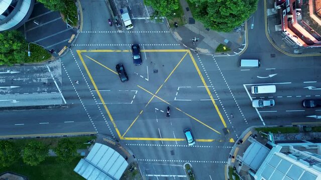 Aerial drone bird's-eye view of traffic cars on motorway road busy street with roundabout intersection lights Farrer Park Singapore Asia transportation