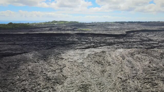 Drone pans, revealing vast scale of lava fields on Big Island, Hawaii, from Leilani Estates