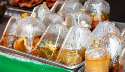 Soups in a bag on the counter. Street food in Thailand
