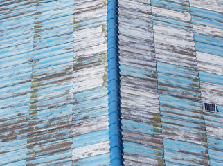 Old blue metal roof as an abstract background. Texture - 791327580