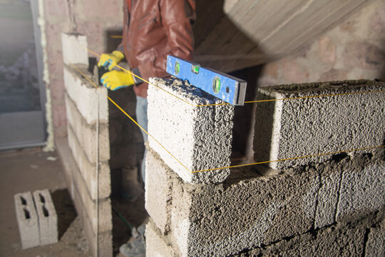 Measure level on brick wall in construction site.