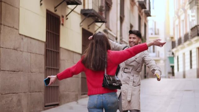 Friends hugging in the street. Meeting friends concept, friendship and love.