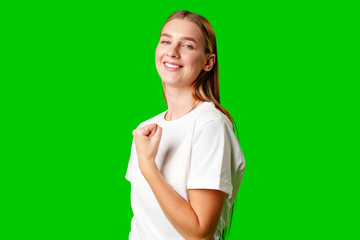 Happy Young Woman Raising Fists against green background