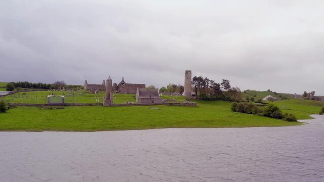 Aerial dolly of Clonmacnoise from the banks of River Shannon. Slow motion