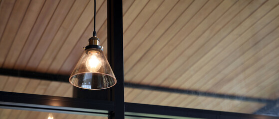 The ceiling lights that illuminate the coffee shop create a shady atmosphere.