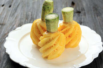 Whole Ripe Pineapple Peeled on White Plate