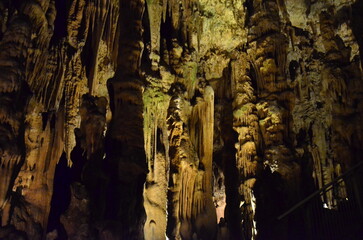 Creepy Underground cave. Eerie atmosphere inside the dark cave. Beams of light piercing through the...