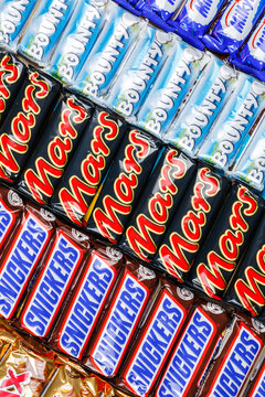 Products of Mars Inc. company like Snickers, Twix, Milky Way and Bounty chocolate bars background portrait format
