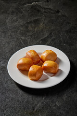 asian deep fried crispy fresh mini lava cheese salted egg yolk custard man tou bun bread vegan bao zi in plate on dark grey table chinese dim sum halal food restaurant cuisine banquet menu for cafe