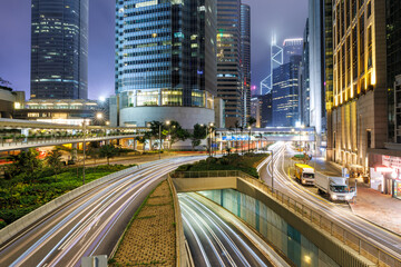 Fototapeta na wymiar Traffic with streets and skyscrapers at night in city of Hong Kong, China