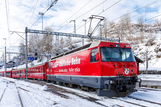 Rhaetian Railway passenger train on Albula line at train station in Filisur, Switzerland