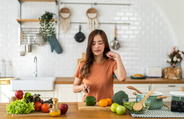 Portrait of beauty body slim healthy asian woman eating vegan food healthy with fresh vegetable salad in kitchen at home.diet, vegetarian, fruit, wellness, health, green food.Fitness and healthy food