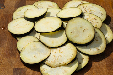 sliced eggplant in heart shape on wooden background