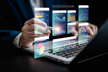 Businesswomen analyze chart data business on a visual screen dashboard laptop, technology devices and screens visible in the background, financial planning, market research, and the stock market.