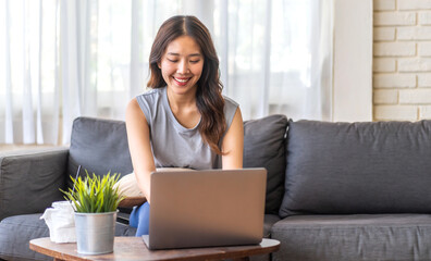 Obraz na płótnie Canvas Young smiling asian woman happy relax use laptop conference work,learning, education, shopping, study online, webinar, online marketing, business, blog, digital internet advertising at home