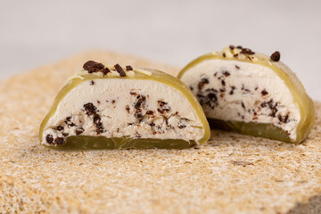 Traditional Japanese dessert, mochi cake mint filling with bitter chocolate, tea treat, close-up of the cut