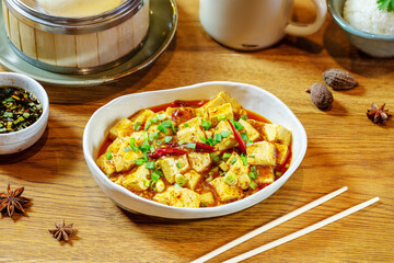 Tofu in red sauce with pepper and green onions. Chinese food.