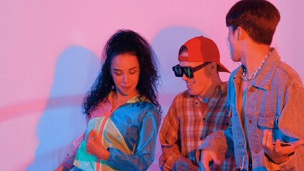 Close up of break dancer team dancing together at modern studio with pink led light. Multicultural...