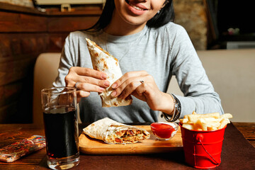 Woman Enjoying a Burrito at Table
