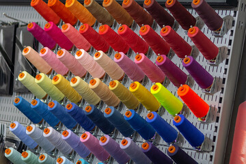 Multi-colored threads on a stand close-up.