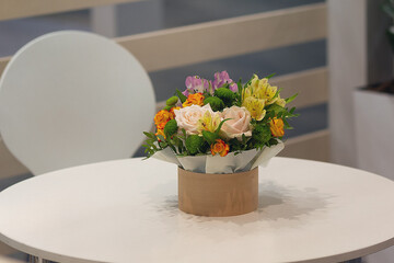 Beautiful bouquet of roses on the table in the meeting room