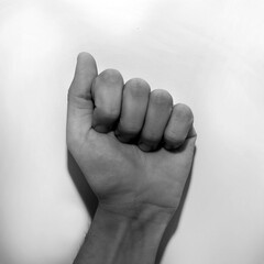 Letter A in American Sign Language (ASL) for deaf people, black and white monochrome photo