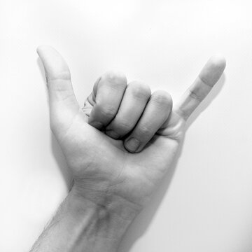 Letter Y in American Sign Language (ASL) for deaf people, black and white photo of a hand