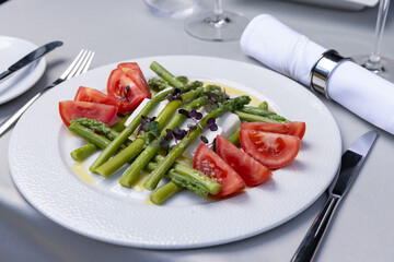 Caprese salad with asparagus served on a plate - 791378597