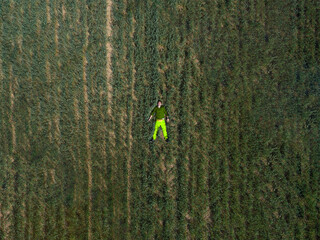 A man laying in a green field