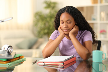 Black student studying hard at home