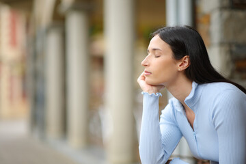 Woman relaxing and resting with closed eyes in the street - 791380798
