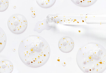 serum pipette serum gel essence texture with gold on white background