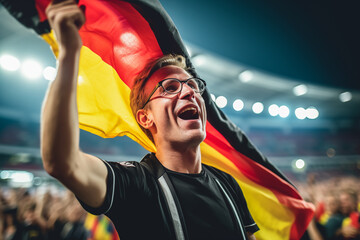 Happy German fan at stadium with flag in german color.