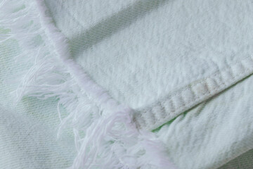 Close up of light mint jeans with white fringes , cotton fabric texture