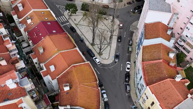 Drone following a motorbike driving on the streets of Lisbon. Shooting from above.