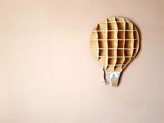 Vintage hot air balloon on the wall background. Space for text.