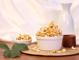 Popcorn for a plate and a cup of dipping sauce