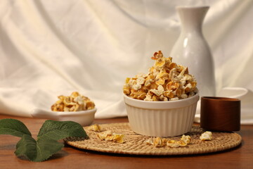 Popcorn for a plate and a cup of dipping sauce