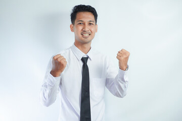 Young Asian business man showing happy excited expression with clenched fist