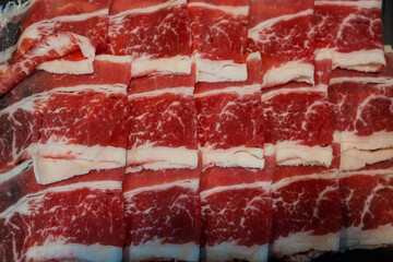 Fresh beef raw sliced with marbled texture served for Sukiyaki and Shabu or Yakiniku