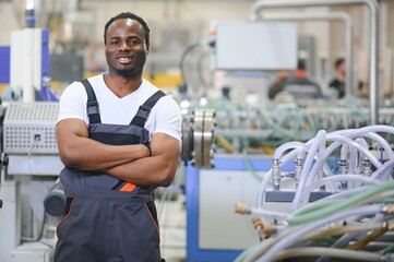 An African-American male worker in a plastic window frame factory