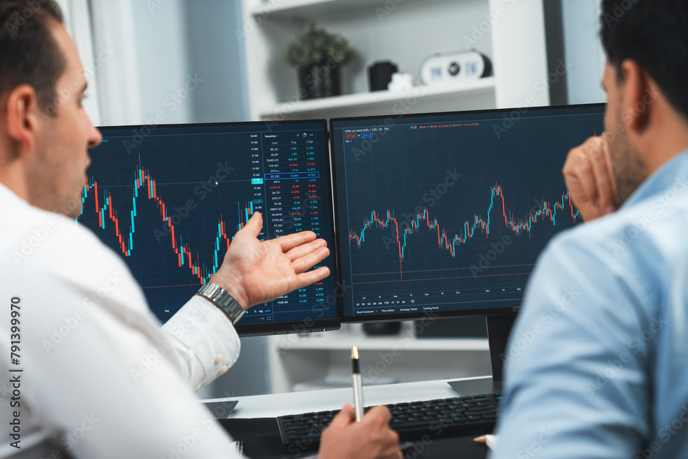 Poster stock traders discussing on research market stock database at real time by using two pc screen for c