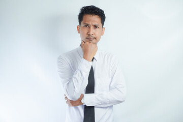 Young Asian man wearing white shirt showing thinking gesture