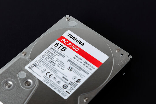 Dnipro, Ukraine - April 13, 2024: 6 TB hard drive, a simple six terabyte 35-inch hard drive from TOSHIBA, close-up isolated on a black background.