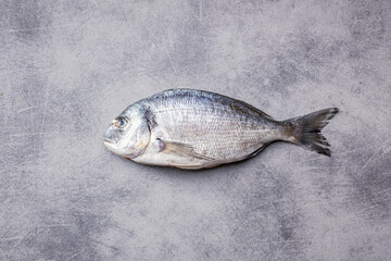 Fresh sea bream fish on kitchen table. Top view. - 791402167