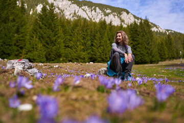 Woman hiker in a field of crocus flowers