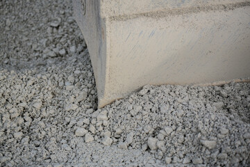 Close-up of bucket of an excavator digging in gravel