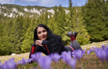 Woman hiker in a field of crocus flowers