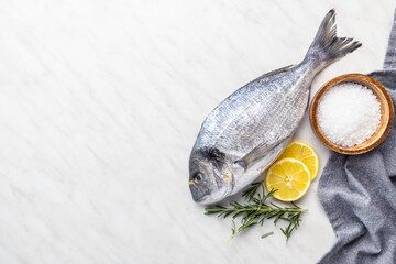Fresh sea bream fish on kitchen table. Top view. - 791402336